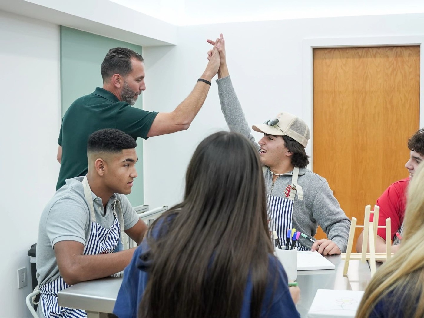 Omar high-fiving a student during a Connect group